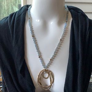 Long beaded necklace with gold pendant